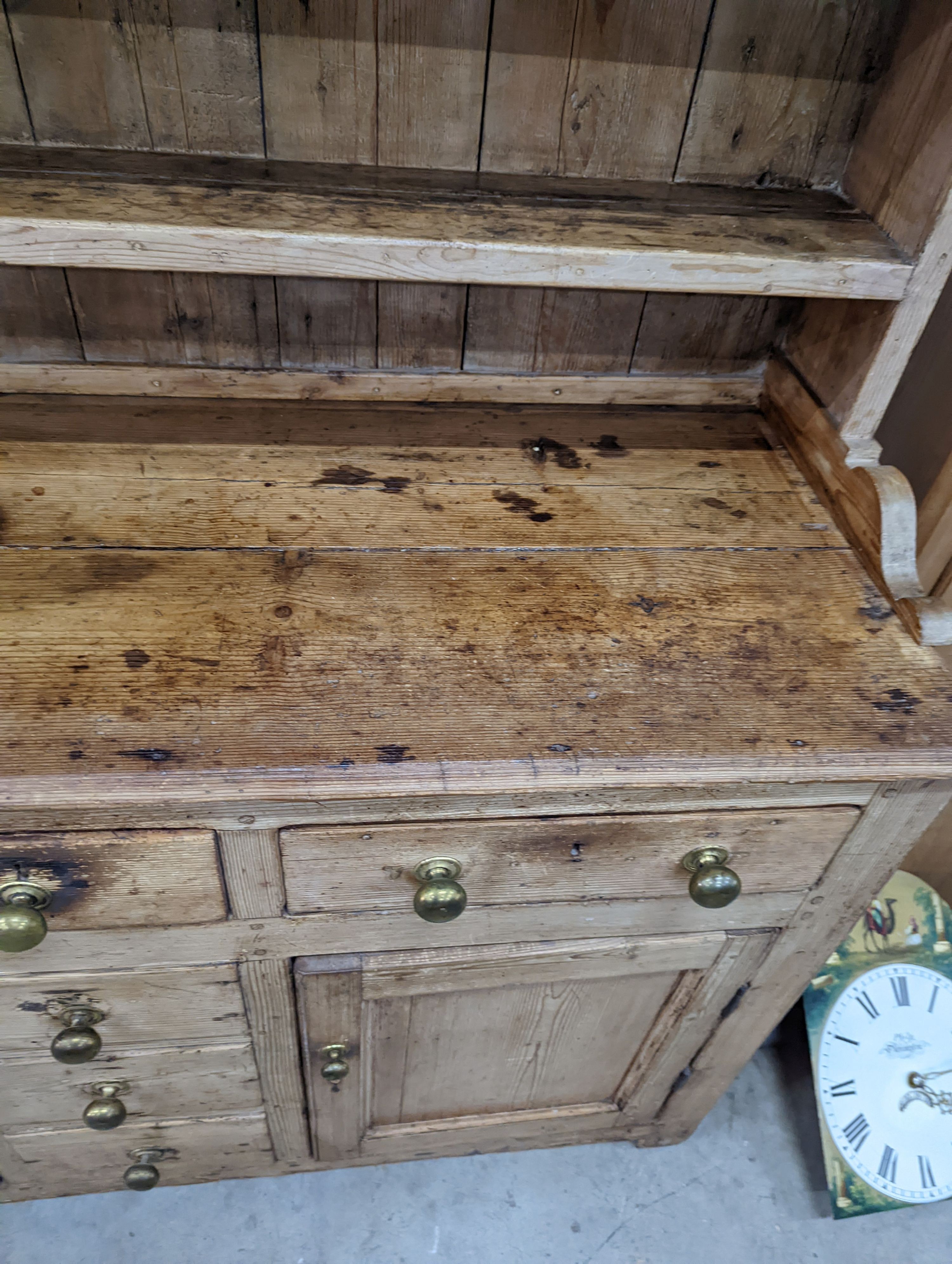 An early 19th century pine dresser with boarded rack, width 141cm, depth 49cm, height 206cm